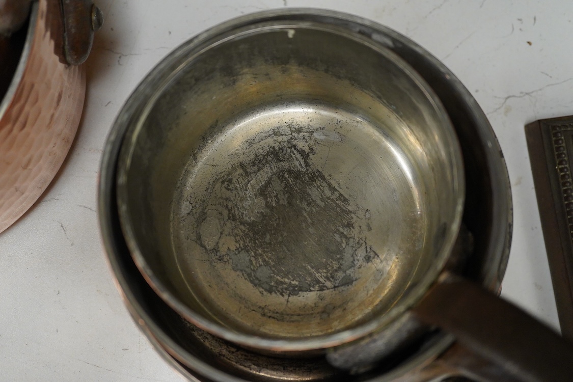 A set of five graduated hammered copper saucepans, largest 37cm in length